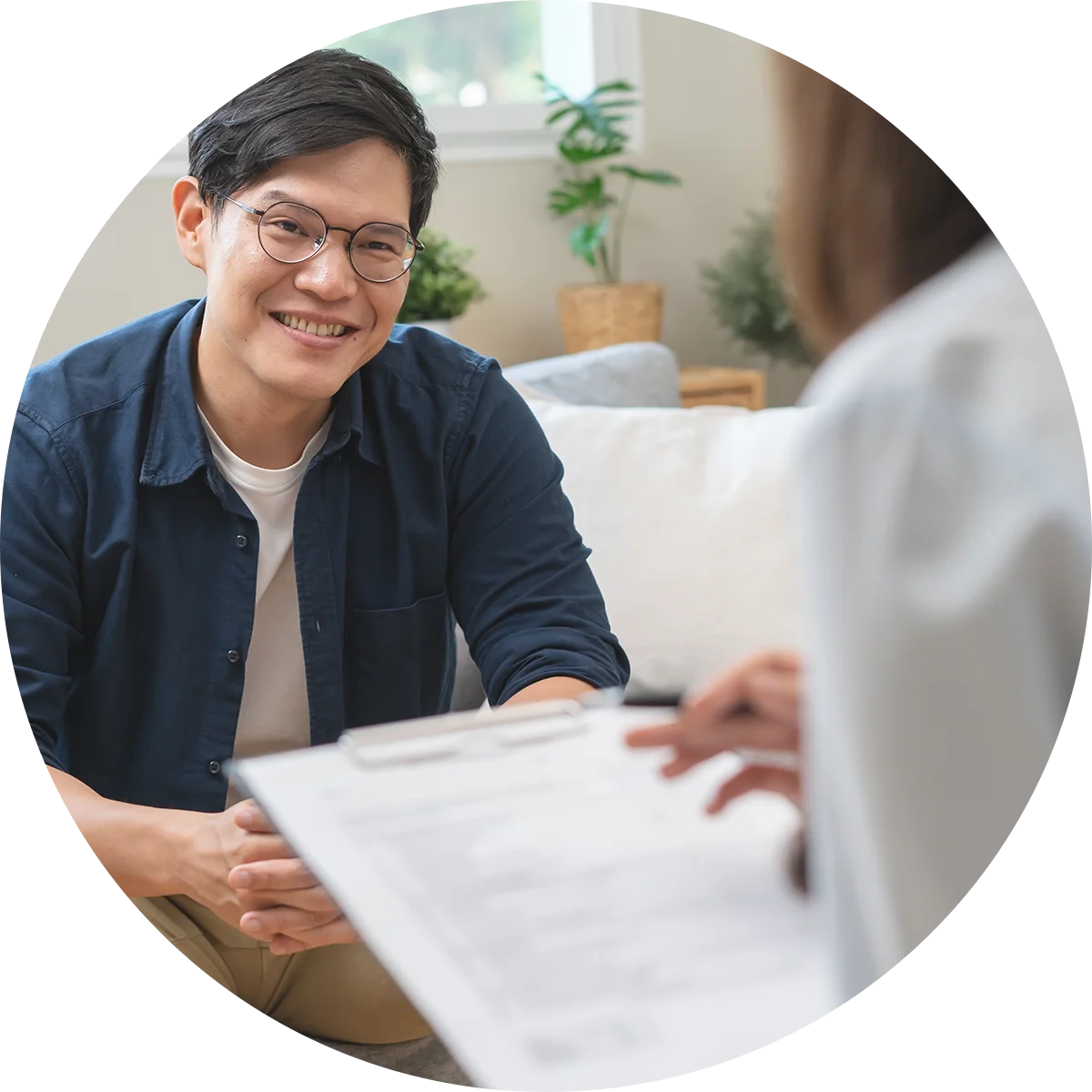 A young man smiles at his therapist while participating in a therapy program at Juniper Grove Recovery.
